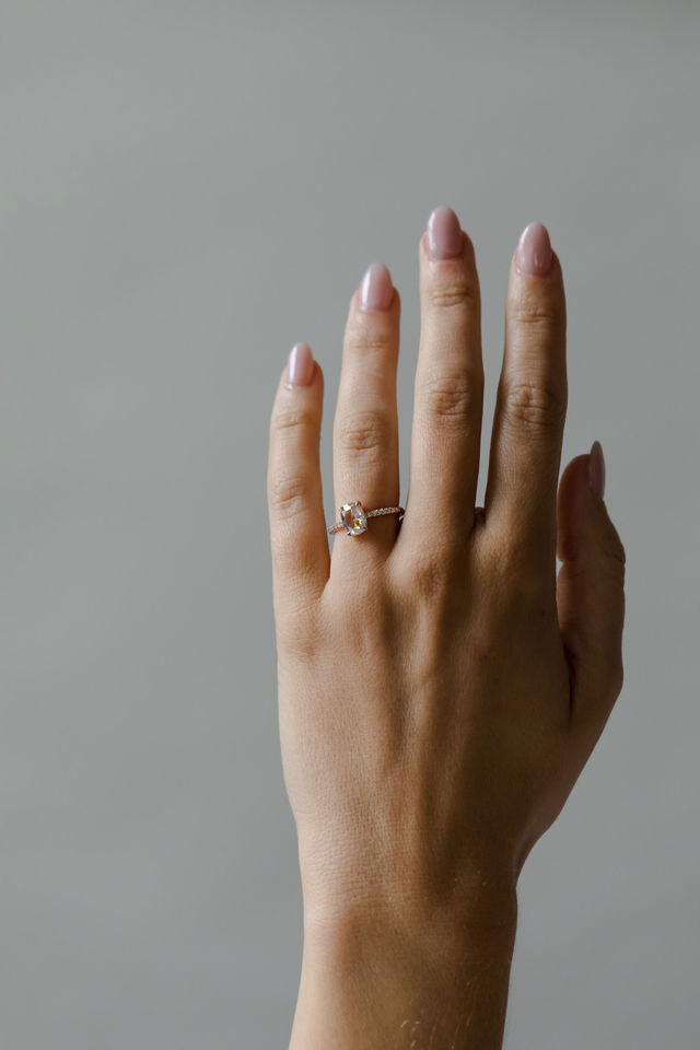 Model wearing the Chloe Solitaire Engagement Ring in gold by Fluid Jewellery 3