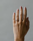 Model wearing the Chloe Solitaire Engagement Ring in gold by Fluid Jewellery 3