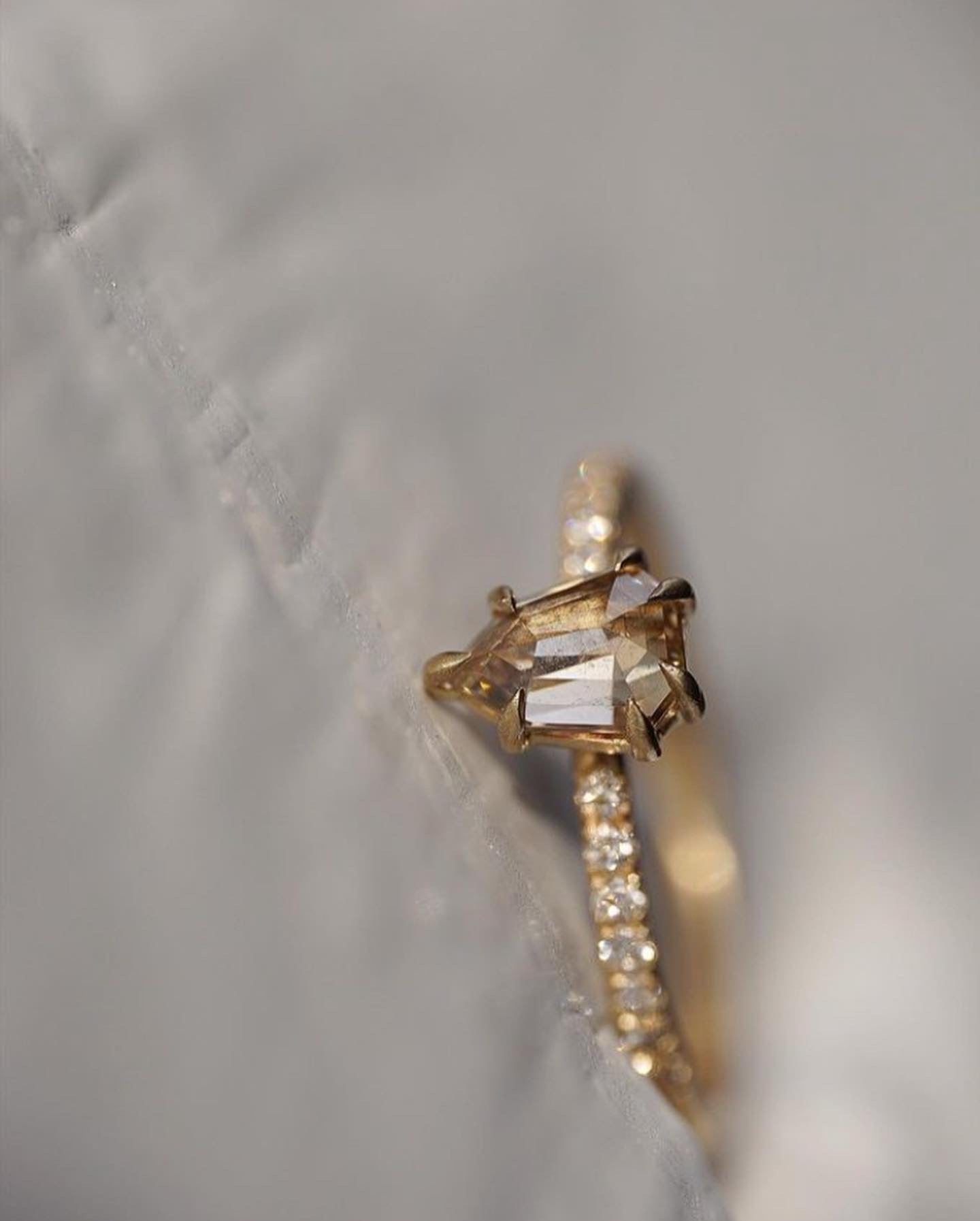 Close up of the Accented Daphne Solitaire Engagement Ring in yellow gold by Fluid Jewellery4