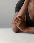 Model wearing the Accented Edith Solitaire Engagement Ring in gold by Fluid Jewellery 2