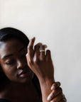 Model wearing the Accented Edith Solitaire Engagement Ring in gold by Fluid Jewellery 4