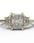 Close up of the Three Stone Merike Engagement Ring in yellow gold by Fluid Jewellery
