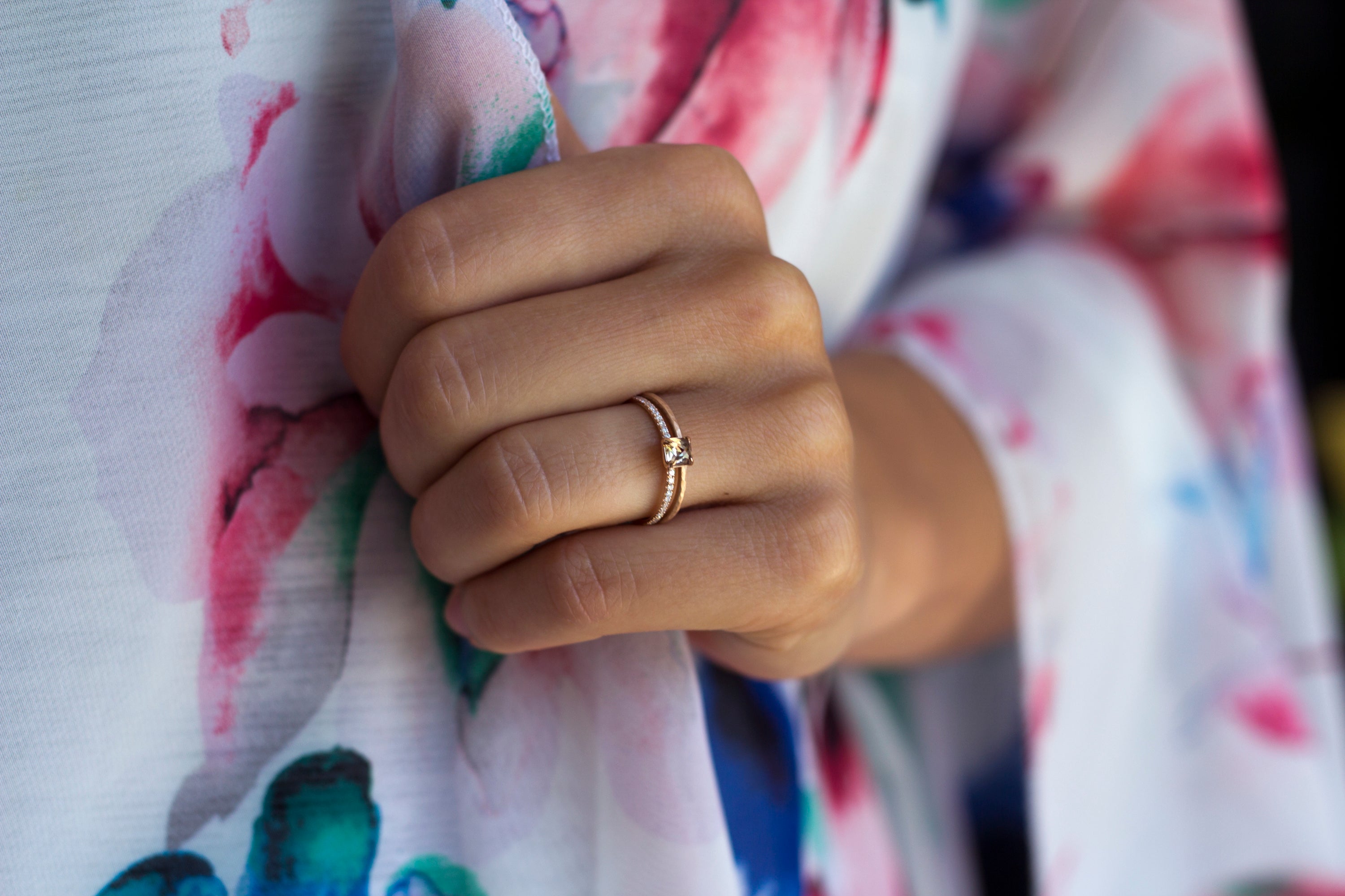 Close up of a model hand wearing the Accented Olivia Solitaire Engagement Ring in yellow gold