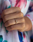 Close up of a model hand wearing the Accented Olivia Solitaire Engagement Ring in yellow gold