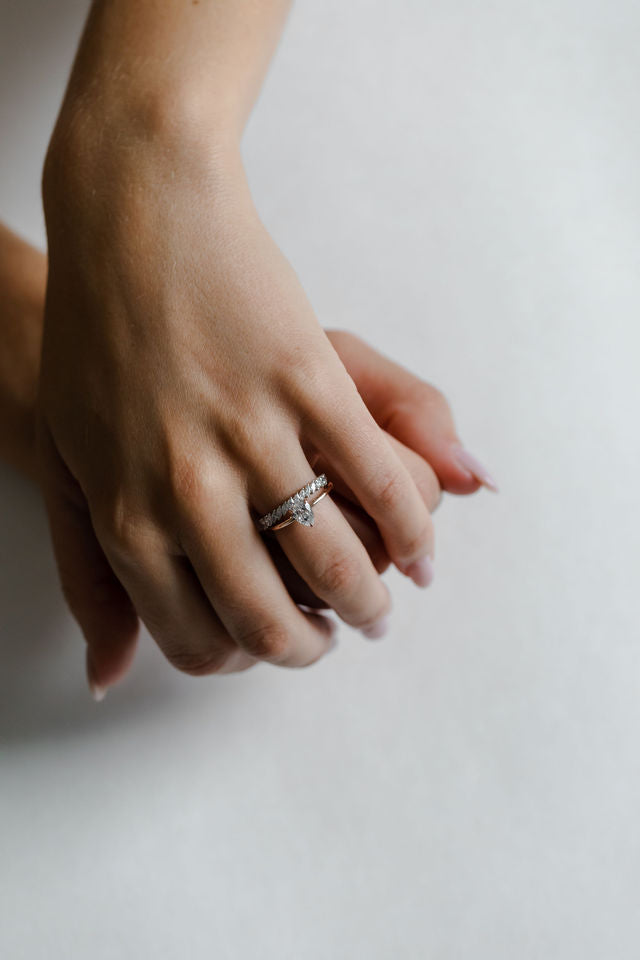 Model wearing the Classic Sula Solitaire Engagement Ring in gold by Fluid Jewellery 3