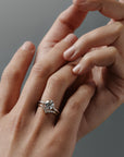 Claudia chevron Fairmined gold wedding band paired with the Compass solitaire engagement ring on a woman's hand.
