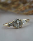 Close-up profile of the Esme hexagon shaped salt and pepper diamond engagement ring with tapered baguette diamonds.