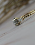 Close-up side profile of the Esme hexagon shaped salt and pepper diamond engagement ring with tapered baguette diamonds.