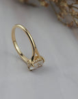 Close-up side view of the Love Knot split shank diamond solitaire engagement ring resting on its side, showing the hidden halo and split shank band.