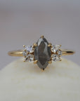 Meghan salt and pepper marquise-shaped rose cut cluster engagement ring featuring a distinctive diamond cluster in a gold setting.