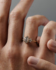 Close-up of the Meghan salt and pepper marquise-shaped rose cut cluster engagement ring worn on a woman's finger.