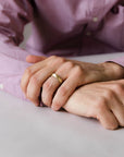 Close up of model hand wearing the mens Half Round wedding band in gold