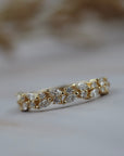 Navette diamond cluster wedding band in gold featuring round and marquise diamonds in a floral inspired design.