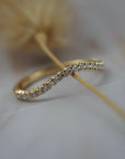 Pernelle curved French pave diamond wedding band featuring closet set Canadian diamonds in a delicate gold setting.