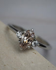 Rebecca three stone engagement ring featuring a champagne toned moval cut diamond accented by white full cut diamonds.