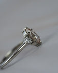 Close-up side profile of the Rebecca three stone engagement ring showing the champagne toned moval cut diamond, white full cuts diamonds, and detailed setting.
