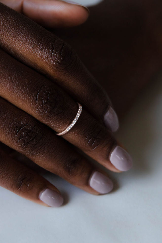 Close up of model hand wearing the Pave Ava womens wedding band by Fluid Jewellery in yellow gold