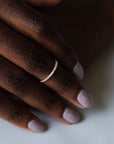 Close up of model hand wearing the Pave Ava womens wedding band by Fluid Jewellery in yellow gold