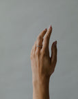 Close up of model hand wearing the classin Evelyn womens wedding band by Fluid Jewellery in gold