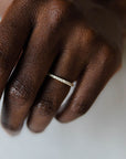 Close up of model hand wearing the classic Eternity womens wedding band by Fluid Jewellery in yellow gold 2