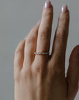 Close up of model hand wearing the cluster Marissa womens wedding band by Fluid Jewellery in yellow gold