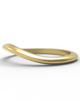 Close up of the curved flow womens wedding band by Fluid Jewellery in yellow gold