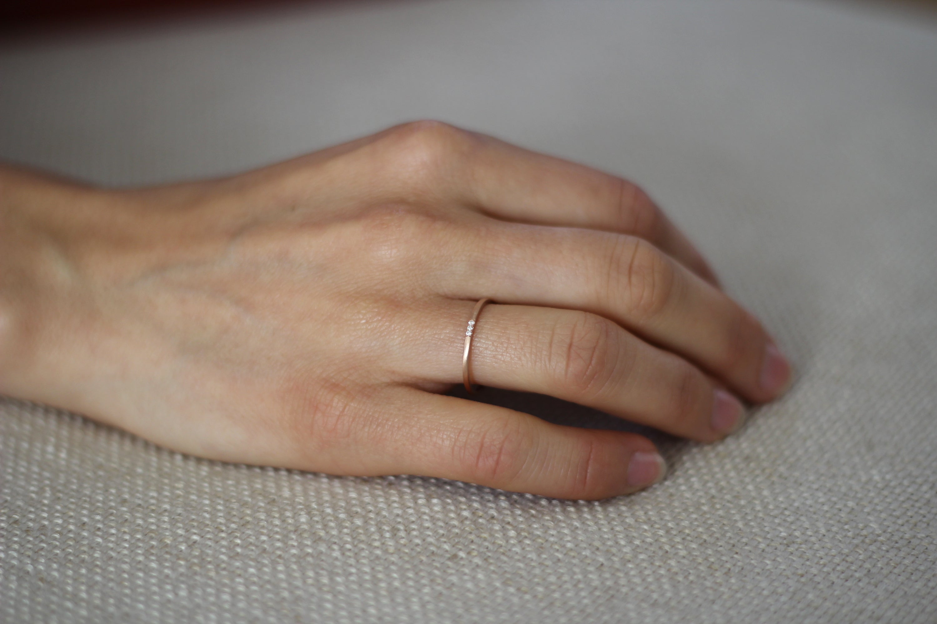 Close up of model hand wearing the Pave Jane womens wedding band by Fluid Jewellery in gold