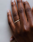 Close up of model hand wearing the Starlight womens wedding band by Fluid Jewellery in gold