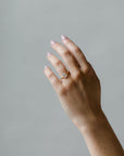 Model wearing the Avery Solitaire Engagement Ring in yellow gold by Fluid Jewellery