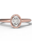 Close up of the Bezel Isla Solitaire Engagement Ring in rose gold by Fluid Jewellery