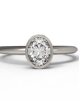 Close up of the Bezel Isla Solitaire Engagement Ring in white gold by Fluid Jewellery