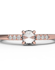 Close up of the Accented Bri Solitaire Engagement Ring in rose gold by Fluid Jewellery