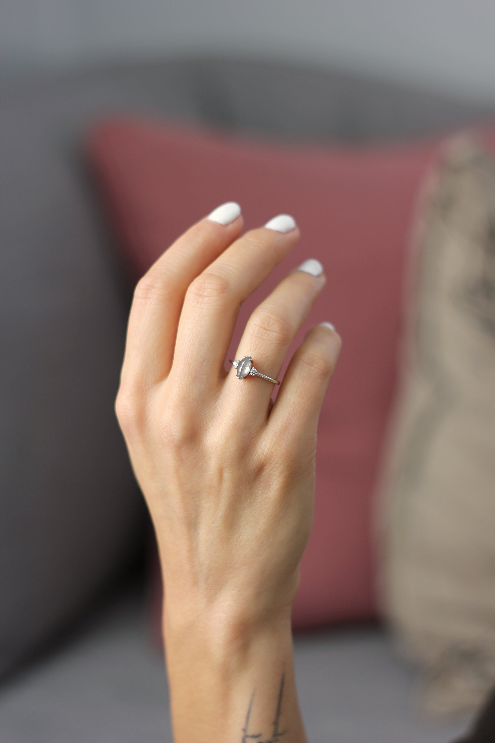 Model wearing the Three Stone Elizabeth Engagement Ring in yellow gold by Fluid Jewellery 3