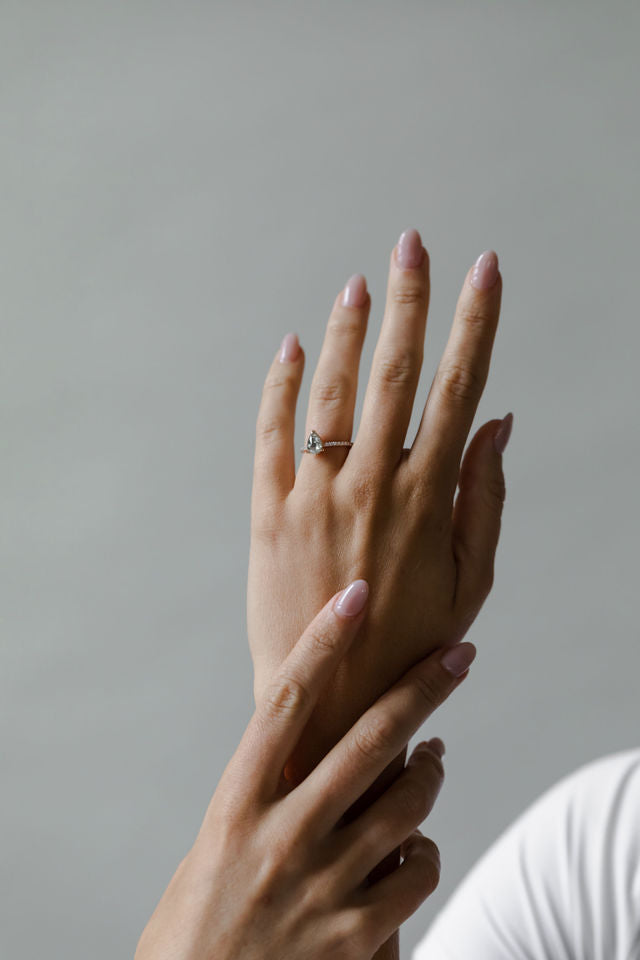 Model wearing the Classic Ivy Engagement Ring in gold by Fluid Jewellery