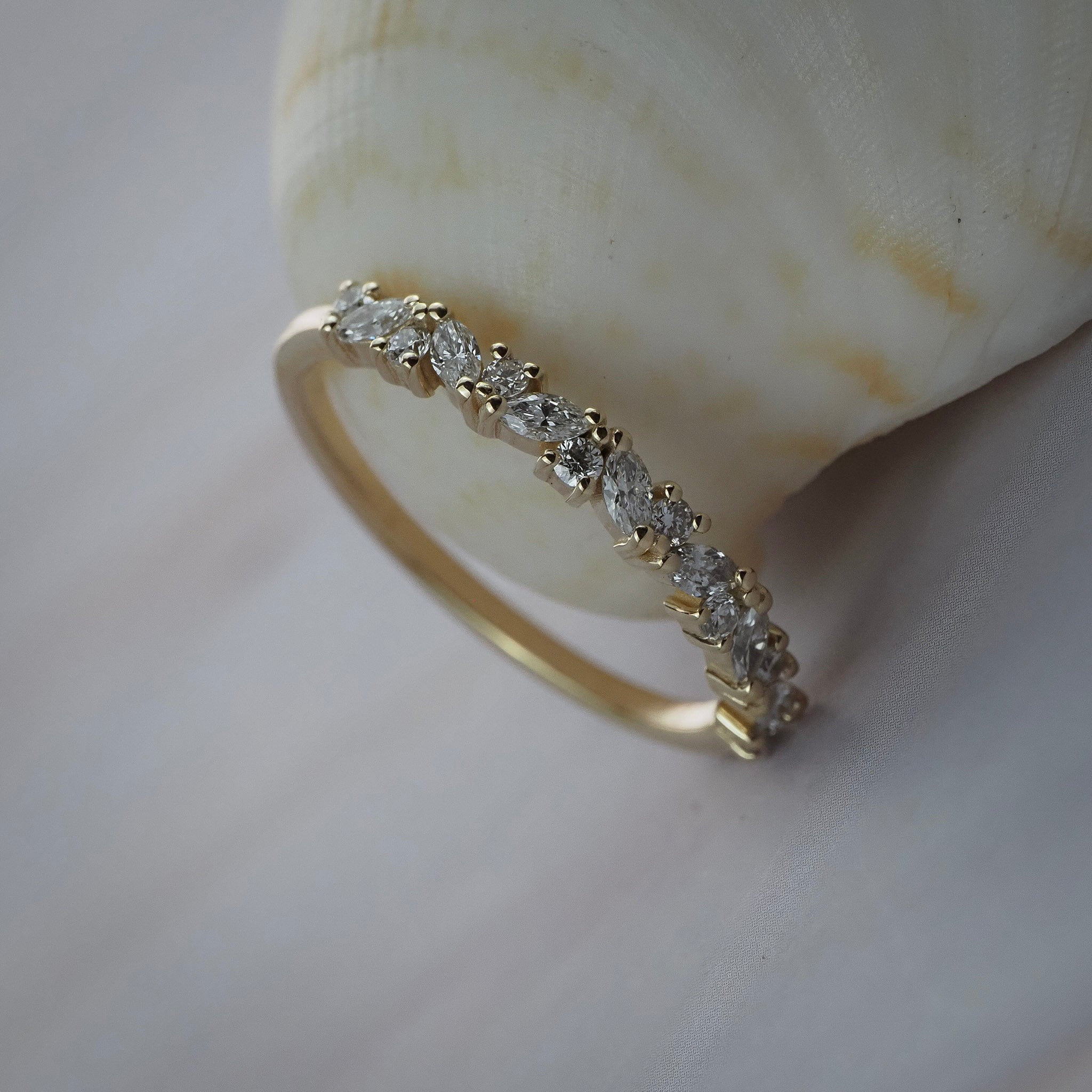 Marissa cluster wedding band featuring round and marquise shaped diamonds in handcrafted gold setting.