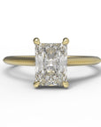 Close up of the Cathedral Sage Solitaire Engagement Ring in yellow gold by Fluid Jewellery