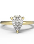 Close up of the Classic Sula Solitaire Engagement Ring in yellow gold by Fluid Jewellery