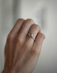Model wearing the Accented Zoe Solitaire Engagement Ring in rose gold by Fluid Jewellery