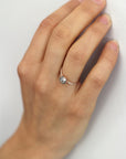Model wearing the Accented Zoe Solitaire Engagement Ring in rose gold by Fluid Jewellery 2