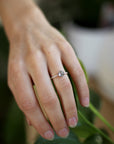 Model wearing the Accented Zoe Solitaire Engagement Ring in rose gold by Fluid Jewellery 3