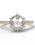 Close up of the Accented Zoe Solitaire Engagement Ring in yellow gold by Fluid Jewellery