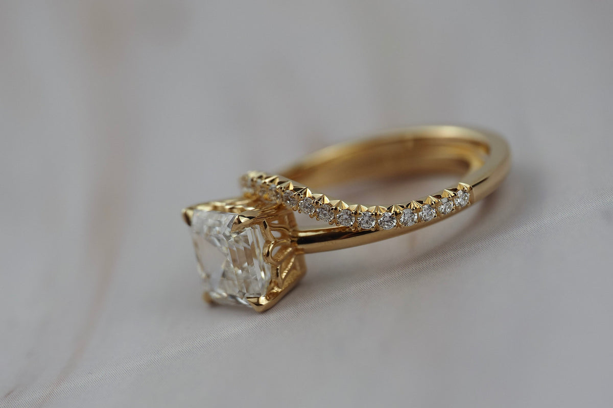 Asscher cut diamond claw solitaire paired with the Pernelle curved French pave diamond wedding band. 