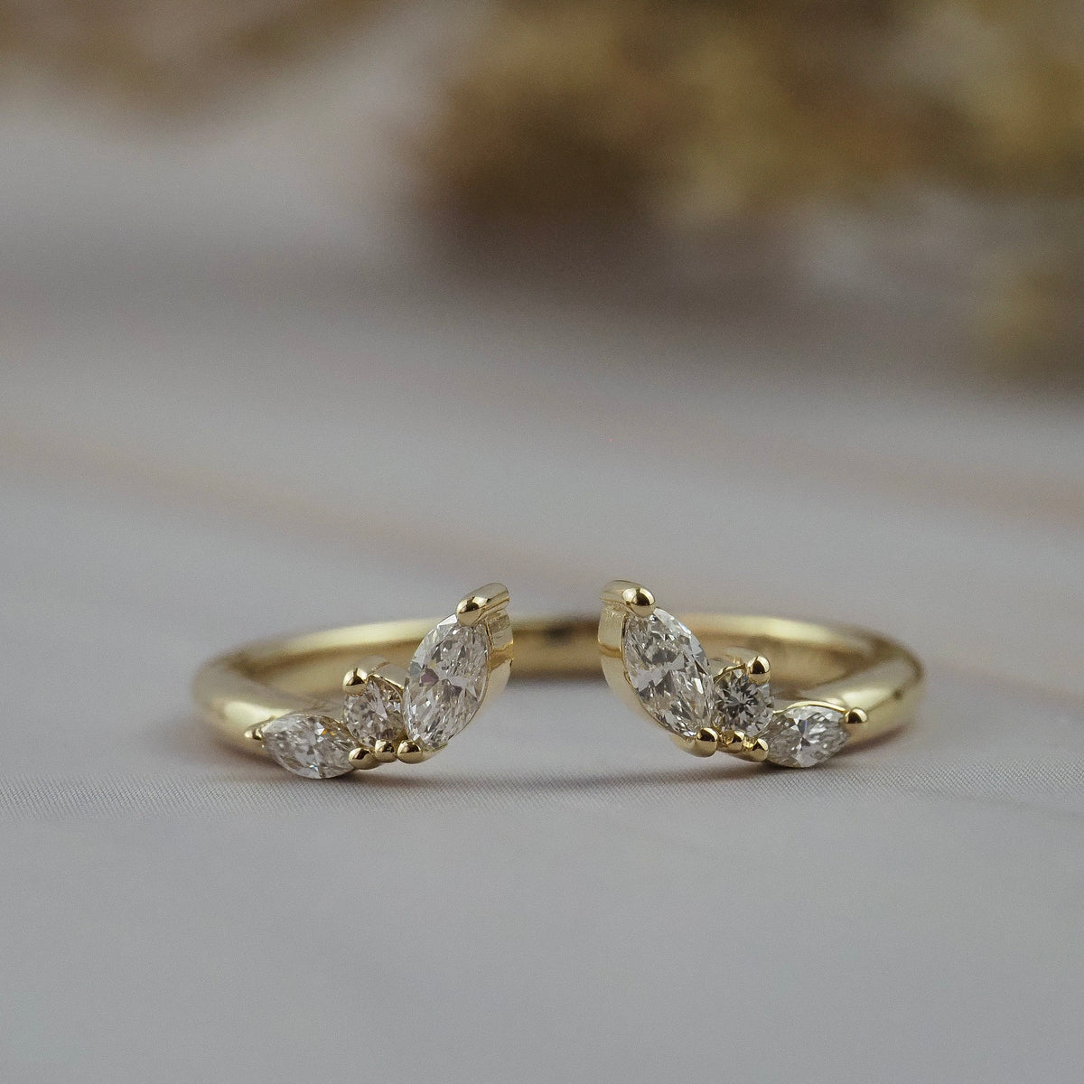 Aster open guard diamond wedding band in Fairmined gold featuring marquise and round diamonds in flower inspired design.