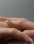 Stylized close-up pf crossed women's hands wearing the Aura halo solitaire with a change-toned Australian salt and pepper rose cut diamond and round Canadian diamonds.