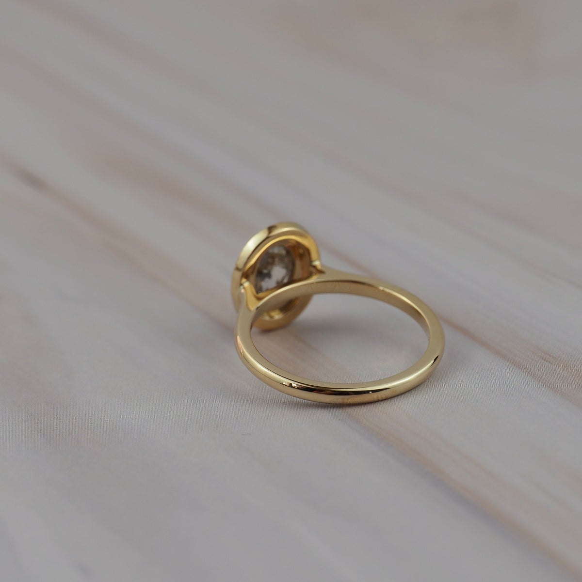 Back view of the Aura halo solitaire showing the setting and band profile.