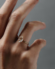 Close-up of a woman wearing the Avery pear shaped rose cut diamond solitaire  engagement ring on her hand.