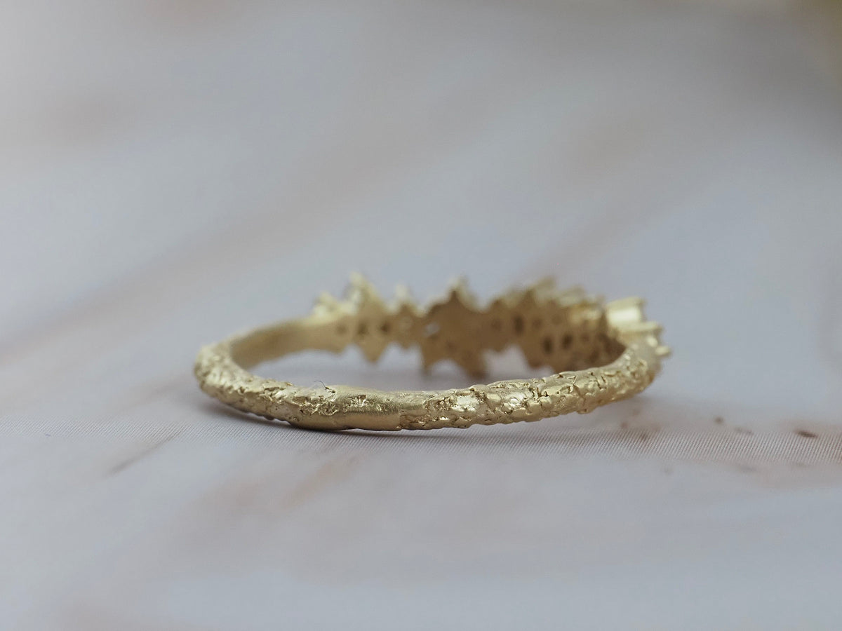 Back view of the Constellation diamond gold wedding band showing it's textured gold finish.