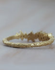 Back view of the Constellation diamond gold wedding band showing it's textured gold finish.