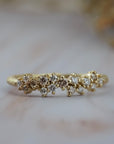 Constellation diamond wedding band in gold featuring delicate diamonds in a scattered star-inspired design.