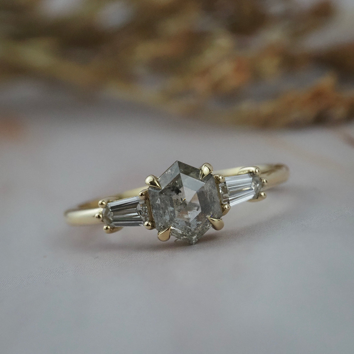 Close-up  profile of the Esme hexagon shaped salt and pepper diamond engagement ring with tapered baguette diamonds.